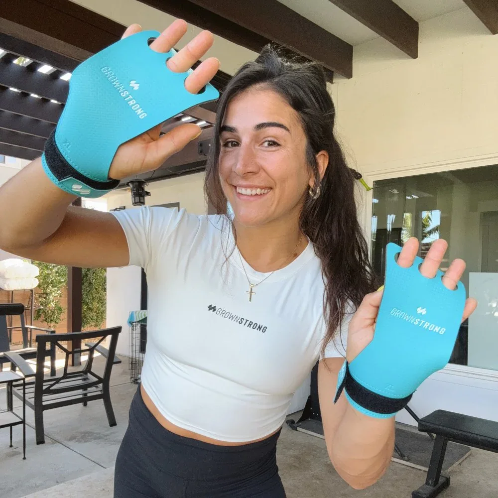 Lauren Fisher holding teal GrownStrong training grips